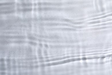 Photo of Closeup view of water with rippled surface on light background