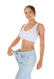 Photo of Young woman wearing oversize pants on white background. Healthy diet