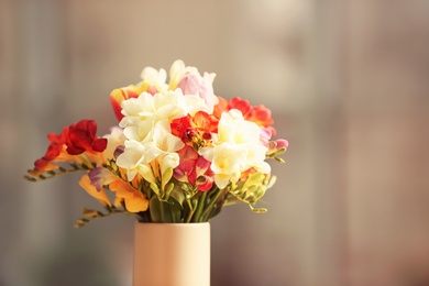 Beautiful bouquet of freesia flowers on blurred background