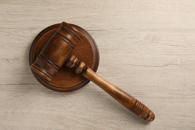 Photo of Wooden gavel on light table, top view