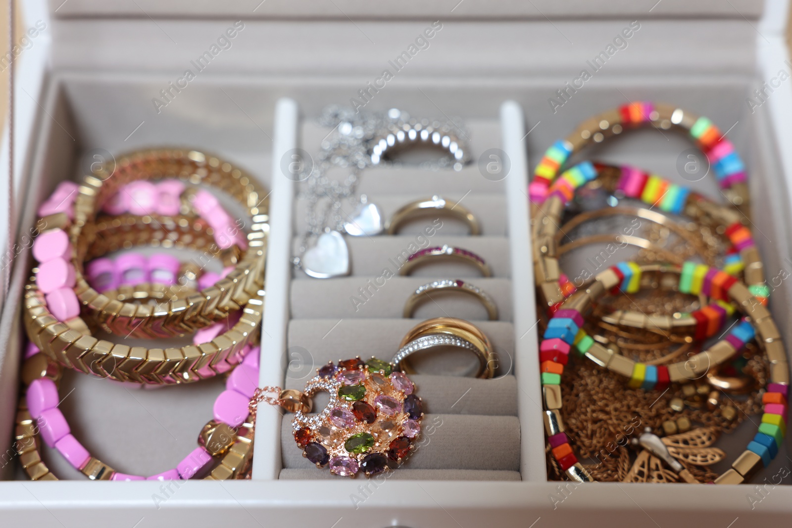 Photo of Jewelry box with beautiful bracelets and other accessories, closeup