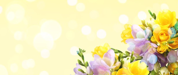 Image of Bouquet of beautiful freesia flowers on beige background, space for text. Banner design