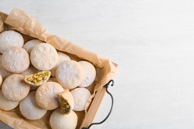 Photo of Traditional Islamic cookies on wooden background, top view with space for text. Eid Mubarak