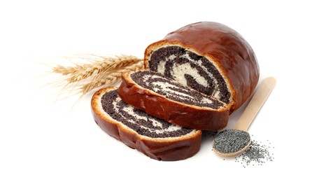 Photo of Cut poppy seed roll, spoon and spikelets isolated on white. Tasty cake