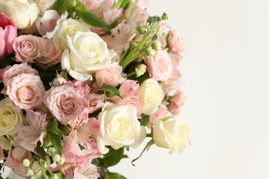Photo of Beautiful bouquet of fresh flowers near white, closeup. Space for text