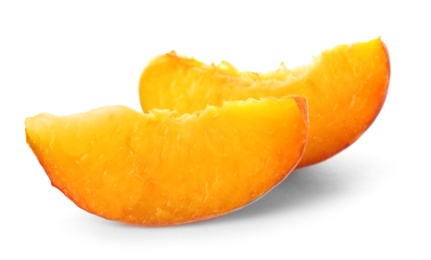 Slices of fresh sweet peach on white background