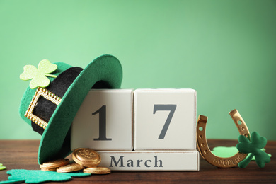 Photo of Composition with block calendar on wooden table. St. Patrick's Day celebration