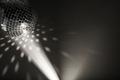 Photo of Shiny disco ball on black background, top view with color toned. Space for text