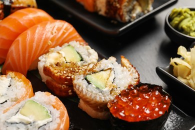 Photo of Set of delicious sushi rolls on table, closeup