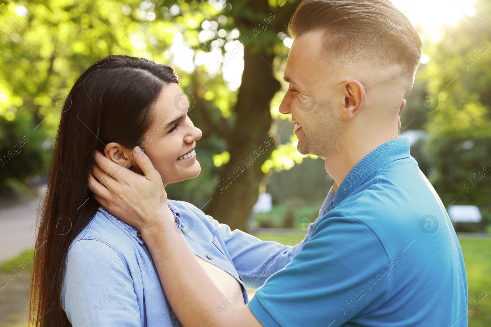 Photo of Happy young couple having good time together in park