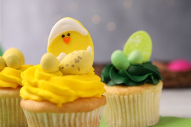 Photo of Tasty cupcakes with Easter decor on table, closeup