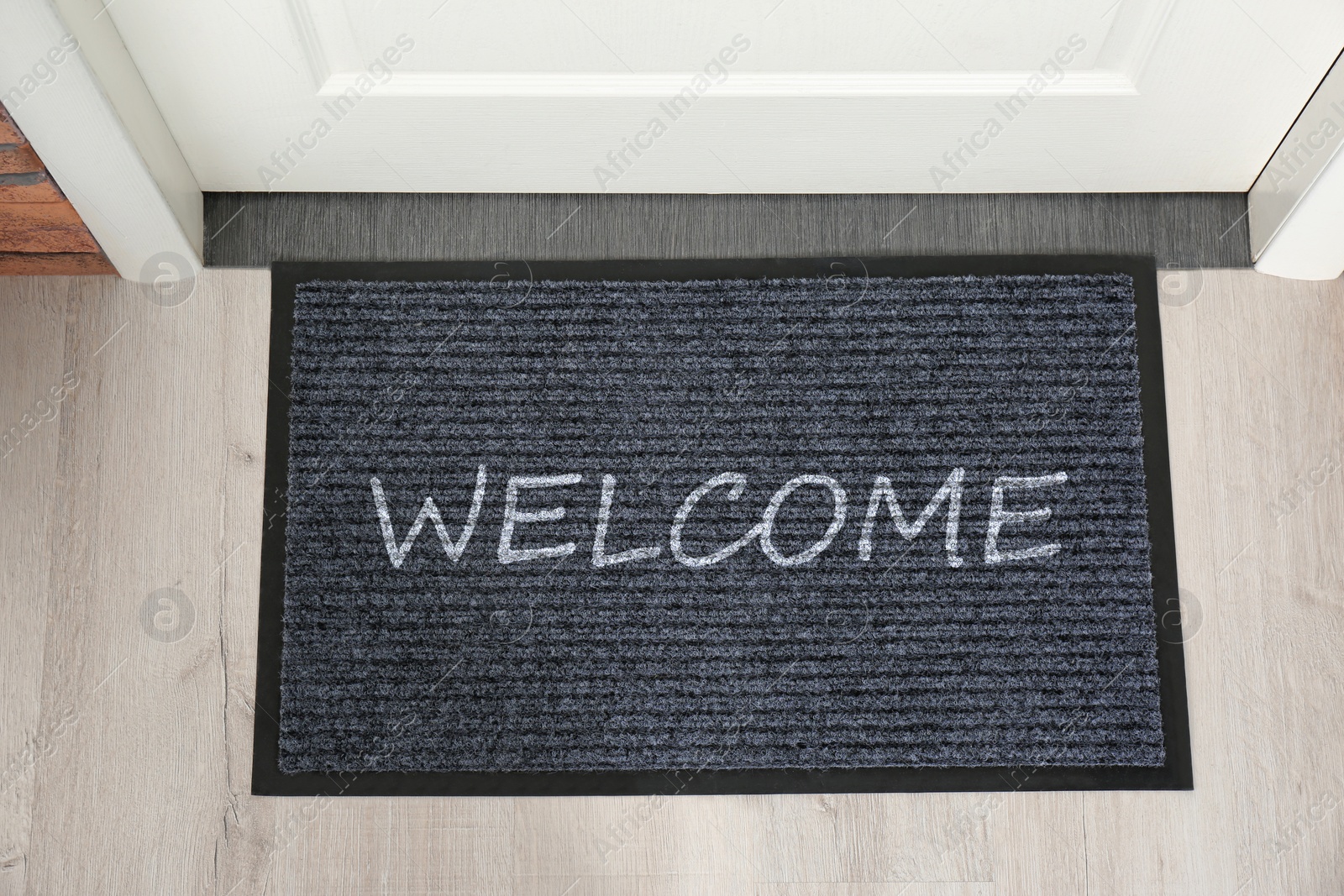 Image of Door mat with word WELCOME near entrance, top view