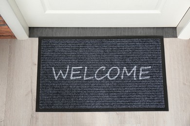 Image of Door mat with word WELCOME near entrance, top view