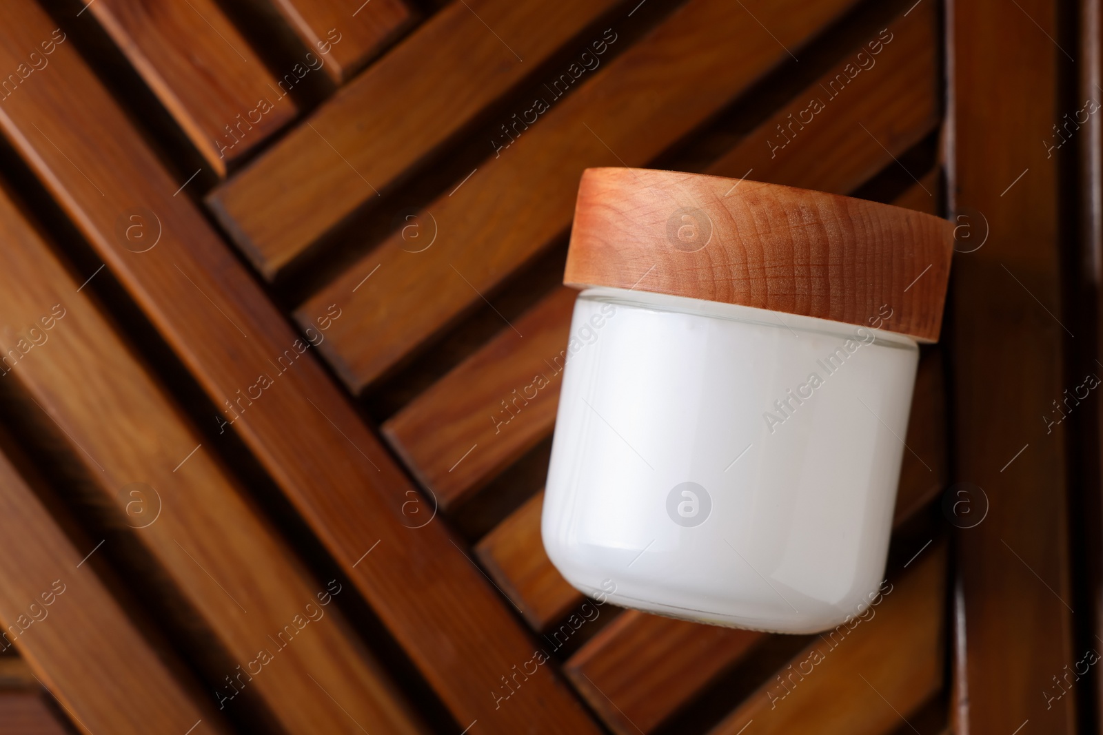 Photo of Jar of luxury cream on wooden background, top view. Space for text