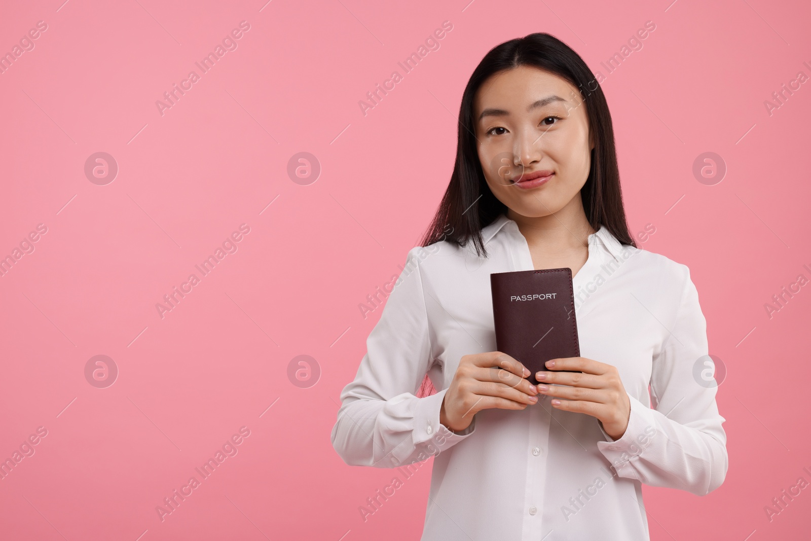 Photo of Immigration. Woman with passport on pink background, space for text