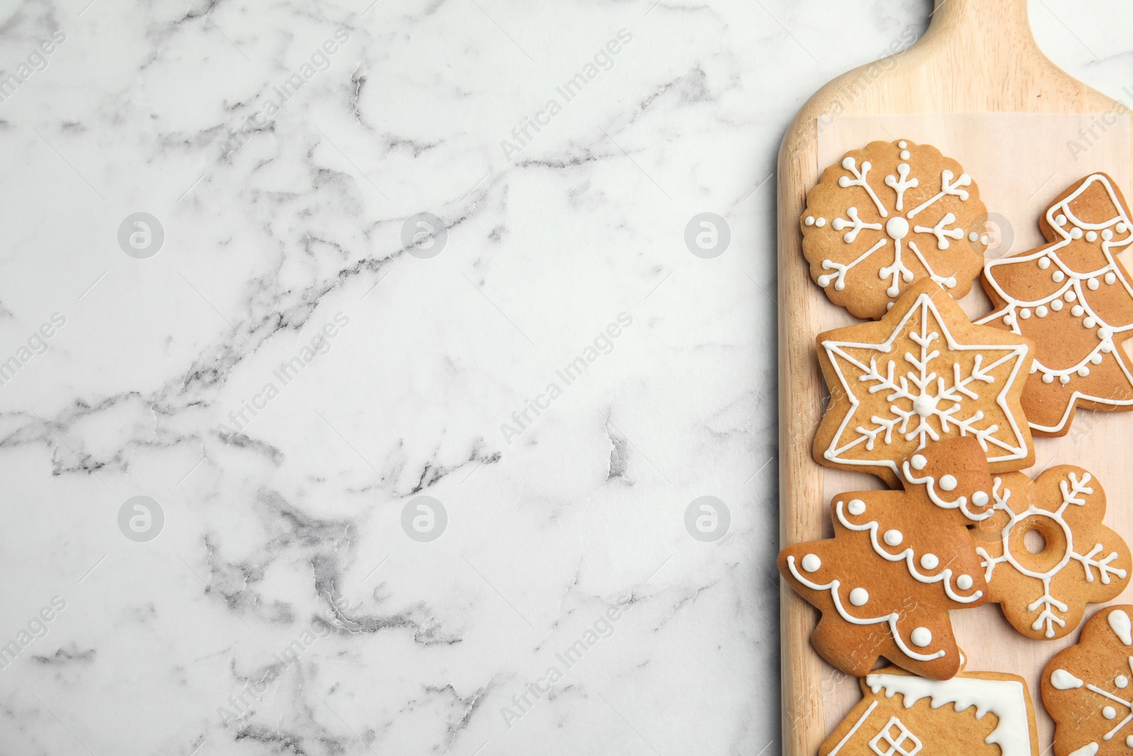 Photo of Board with tasty homemade Christmas cookies on table, top view