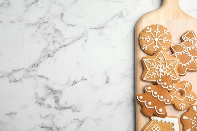 Photo of Board with tasty homemade Christmas cookies on table, top view