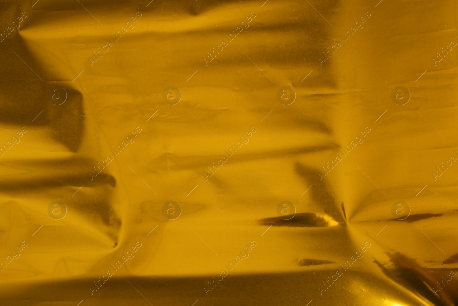 Photo of Plain golden surface as background, closeup view