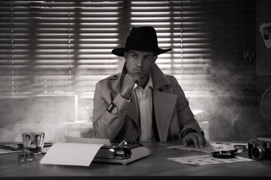 Photo of Old fashioned detective at table in office. Black and white effect