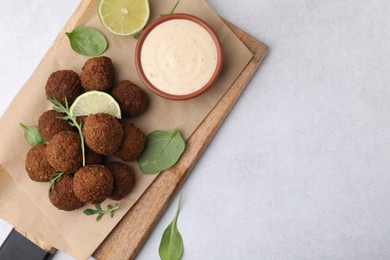 Delicious falafel balls served on light table, top view. Space for text