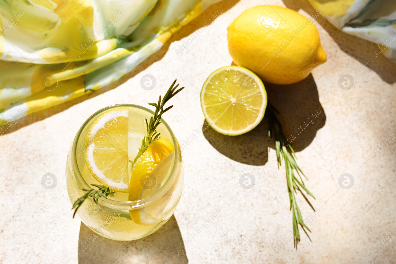 Photo of Summer refreshing lemonade and ingredients on light table, above view