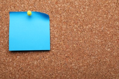 Photo of Blank paper note pinned to cork background. Space for text