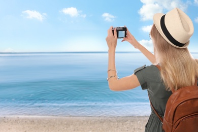 Traveler taking photo on beach during summer vacation trip. Space for text