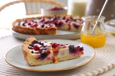 Photo of Piece of delicious currant pie with honey on table indoors, closeup