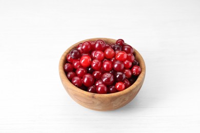 Photo of Fresh ripe cranberries in bowl on white table