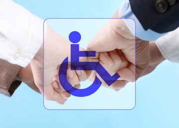 Image of Inclusive workplace culture. International symbol of access. People holding hands together, closeup