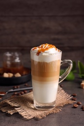 Photo of Glass cup with delicious caramel frappe on table