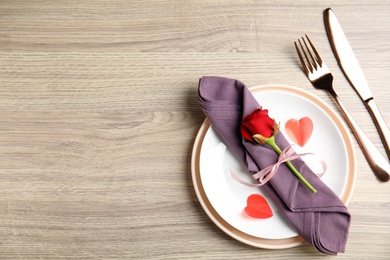 Photo of Beautiful place setting on wooden table, flat lay with space for text. Valentine's day romantic dinner