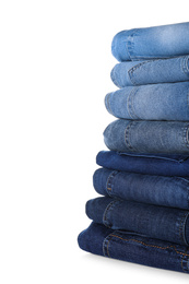 Photo of Stack of different jeans isolated on white