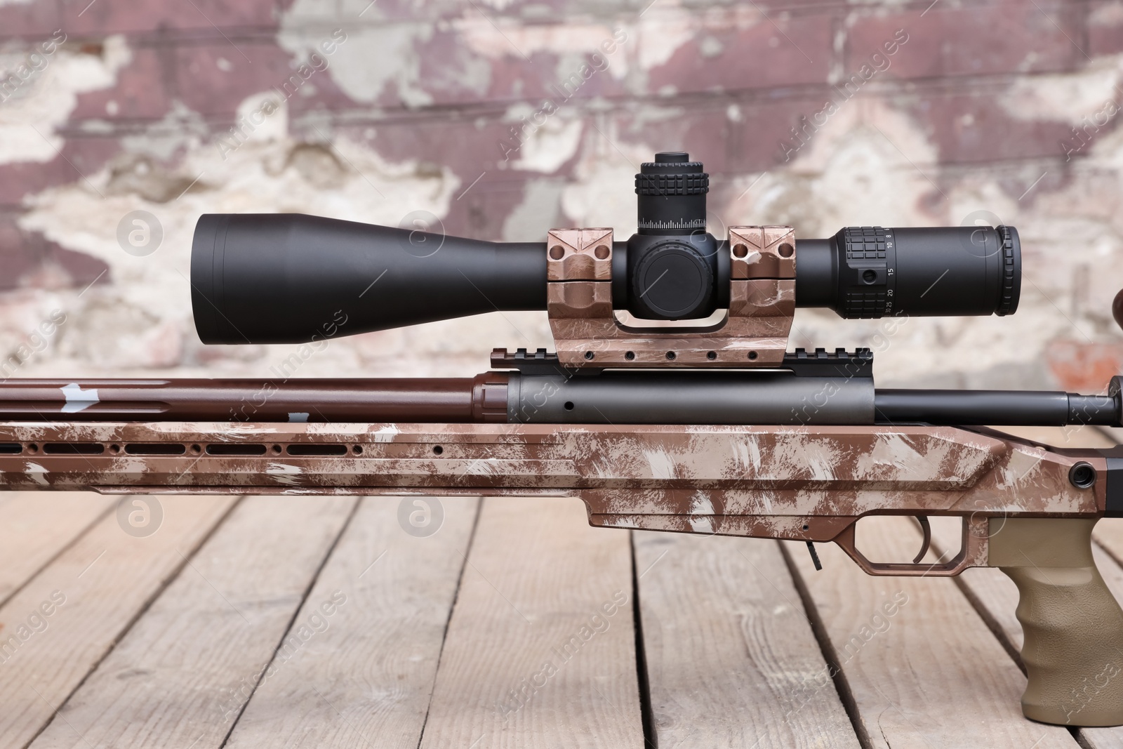 Photo of Modern powerful sniper rifle with telescopic sight outdoors