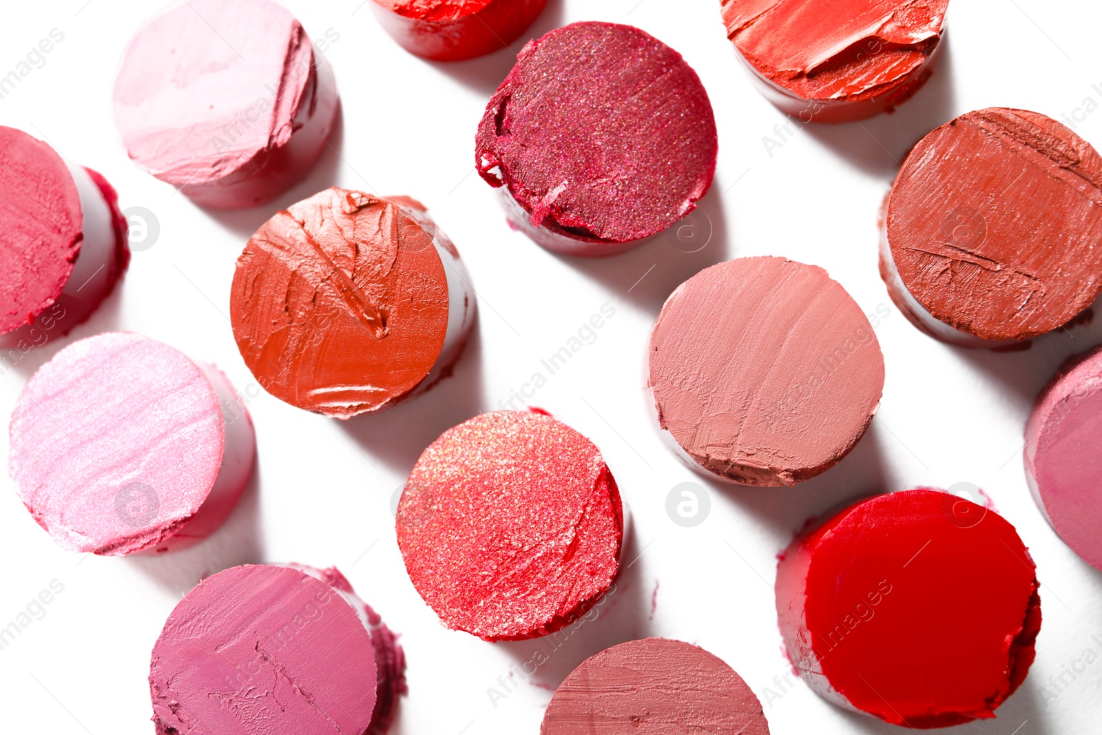 Photo of Different lipstick swatches on white background, top view