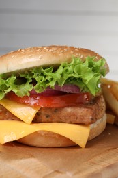 Photo of Delicious burger with tofu and fresh vegetables on wooden table, closeup