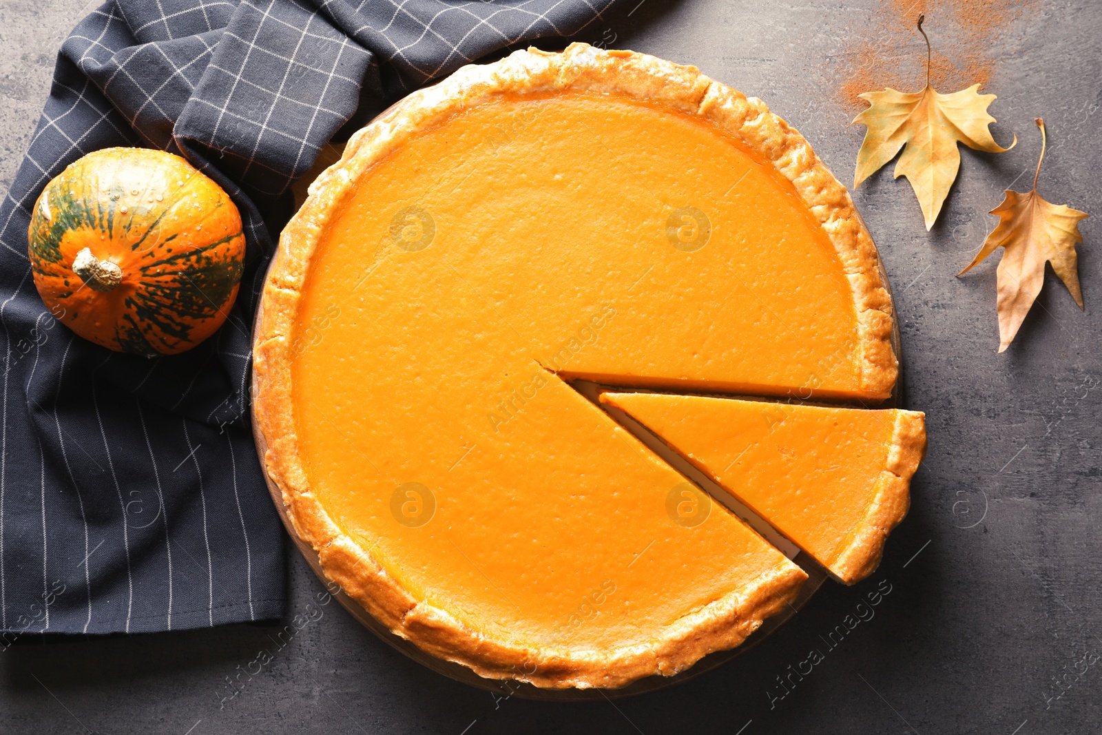 Photo of Flat lay composition with fresh delicious homemade pumpkin pie on table