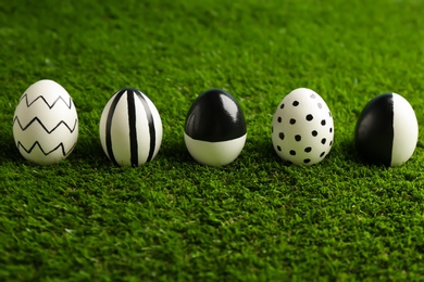 Photo of Line of painted Easter eggs on green lawn