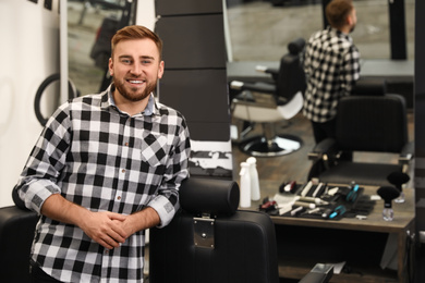 Photo of Young business owner in his barber shop