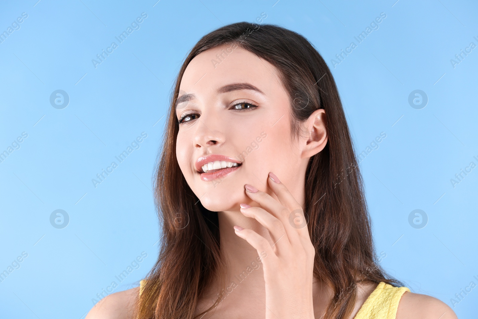 Photo of Teenage girl with acne problem against color background