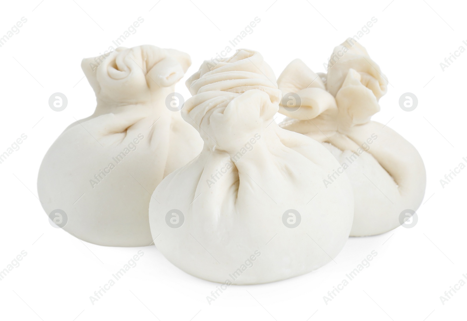 Photo of Uncooked khinkali (dumplings) isolated on white. Georgian cuisine