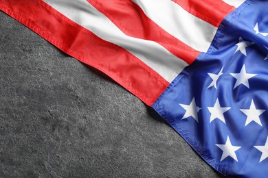 Photo of American flag on grey background, top view. Space for text