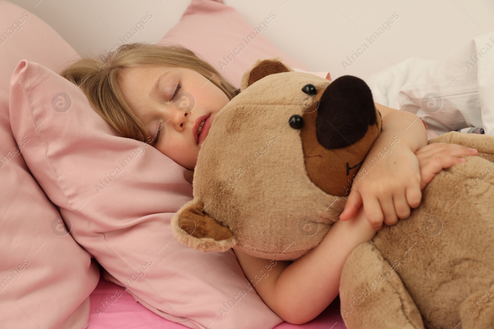 Photo of Little girl snoring while sleeping in bed