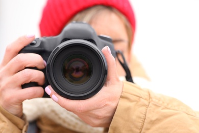 Photo of Photographer taking photo outdoors, focus on camera