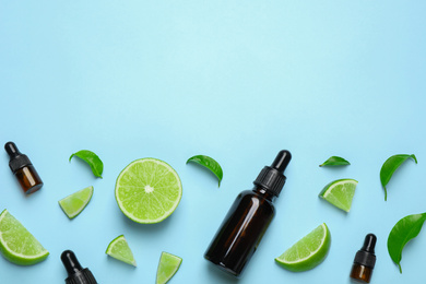 Photo of Flat lay composition with lime essential oil on light blue background. Space for text