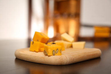 Pieces of delicious gouda cheese on table, closeup