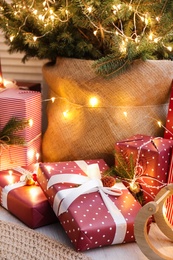 Many different gifts under Christmas tree indoors