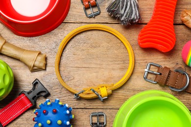 Photo of Flat lay composition with dog collar and toys on wooden table