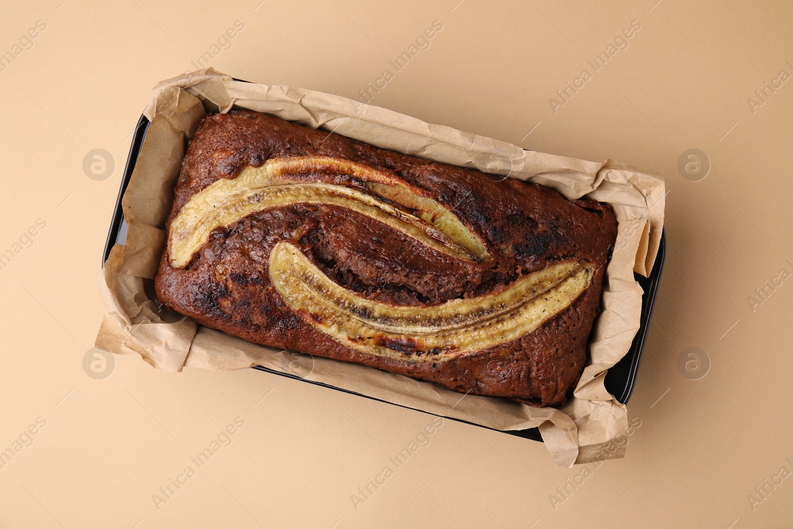 Photo of Delicious banana bread on beige background, top view