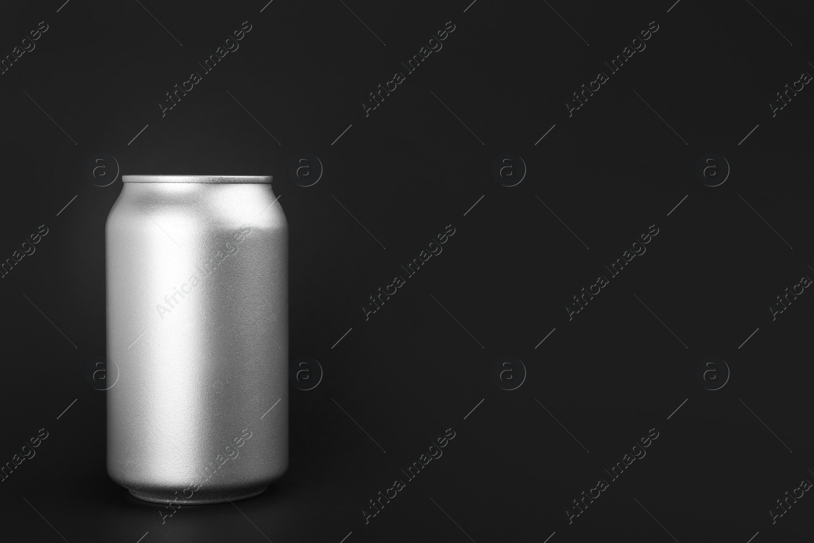 Photo of Can of energy drink on black background. Space for text